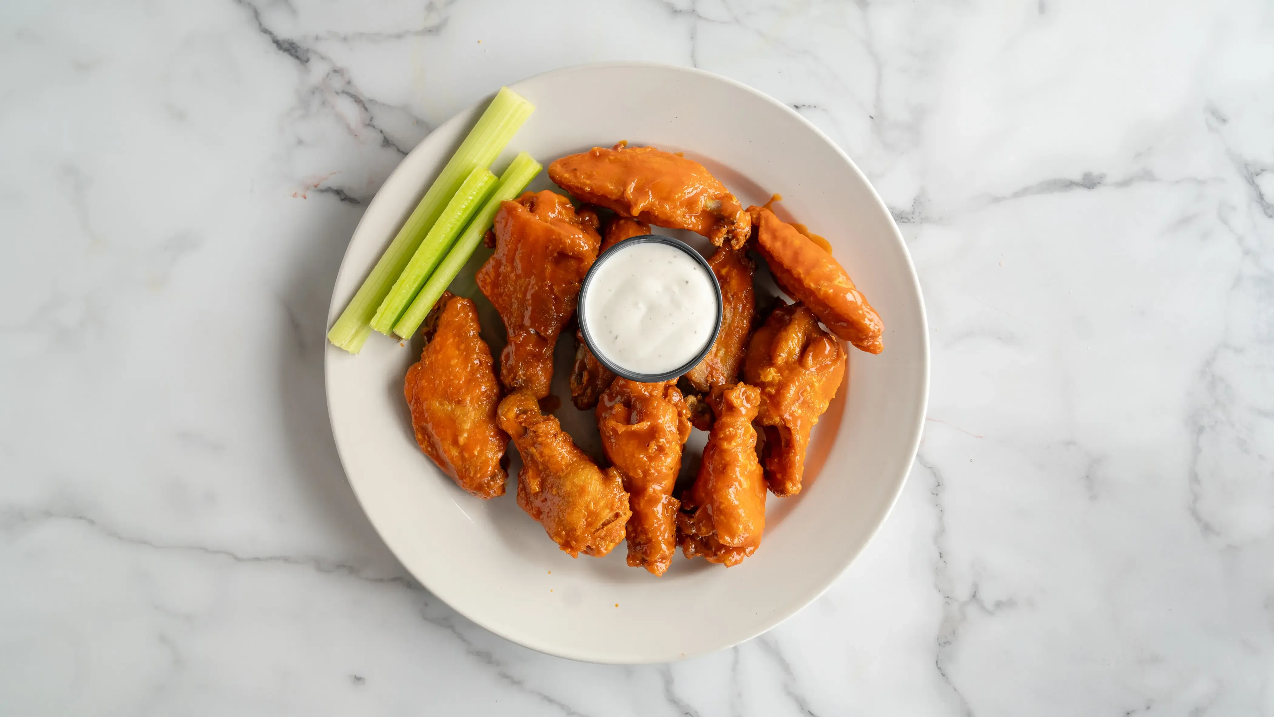 Ten crispy chicken wings tossed in your choice of sauce: classic buffalo, tangy BBQ, or spicy mango habanero. Served with celery sticks and cool ranch or blue cheese dressing