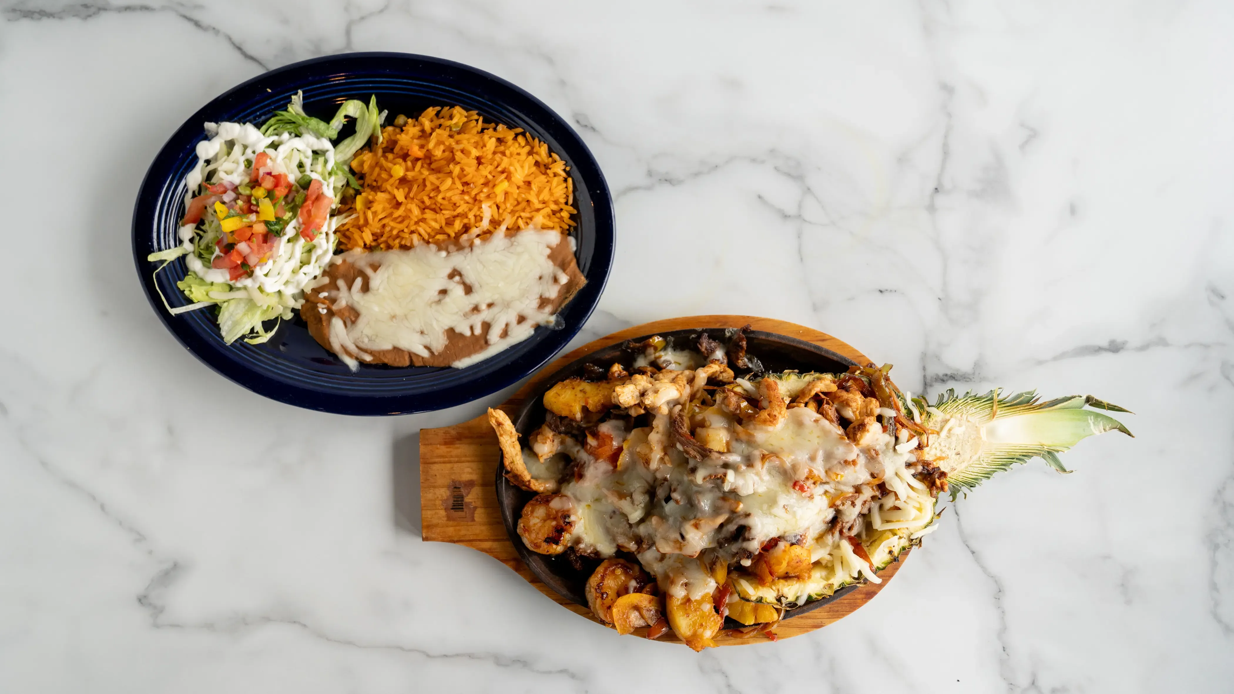 A tropical twist on our classic fajitas! Marinated steak, chicken, and shrimp grilled with sweet pineapple chunks, bell peppers, onions, and tomatoes. The perfect blend of Mexican tradition with island flavors, served with all the fixings