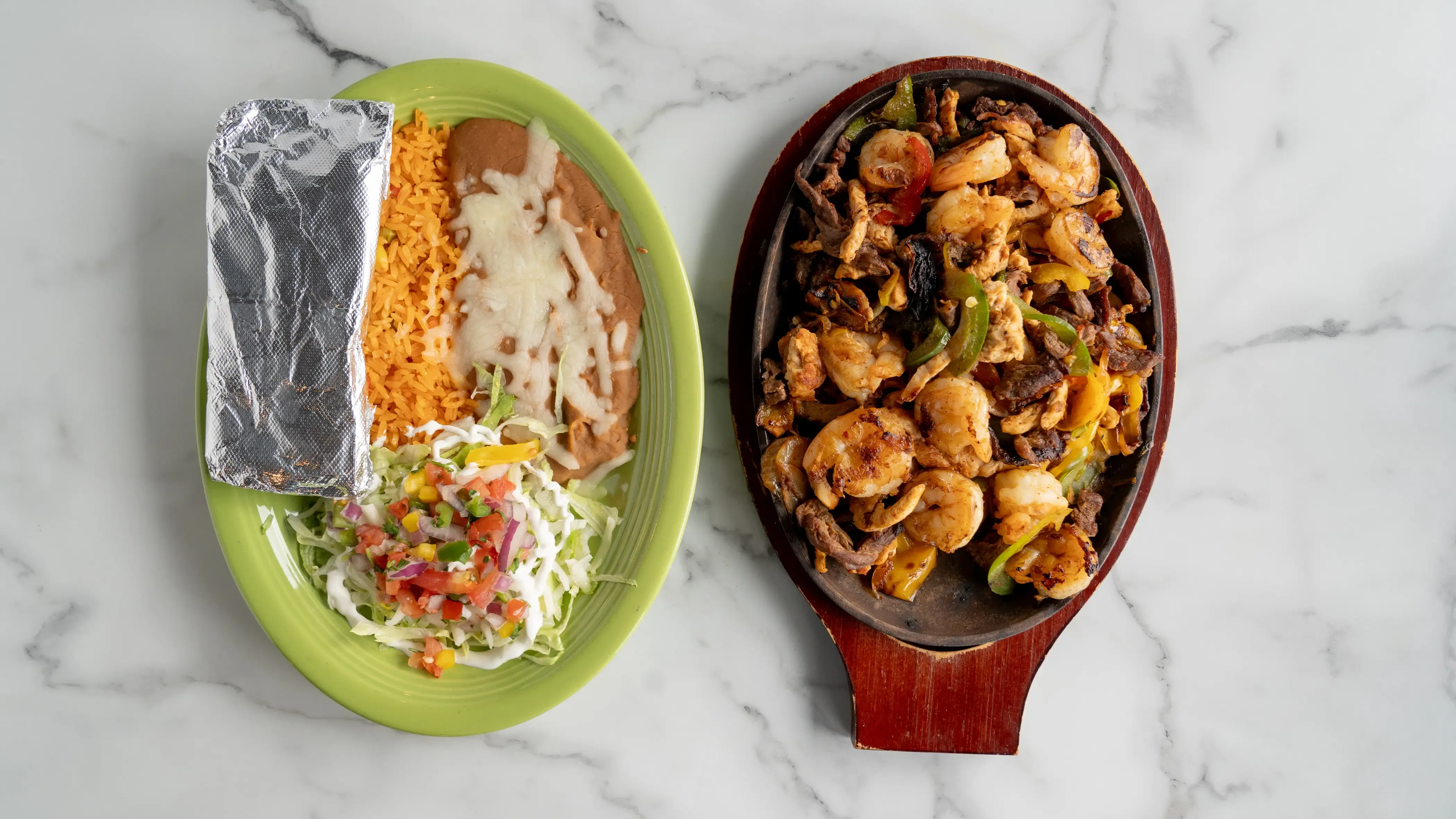Sizzling Mexican fajitas with grilled chicken, bell peppers, and onions on cast iron plate